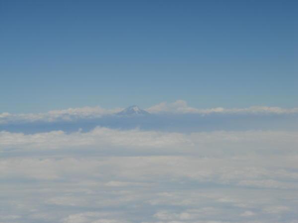 Fist view of Ecuador.. volcano poking through the clouds
