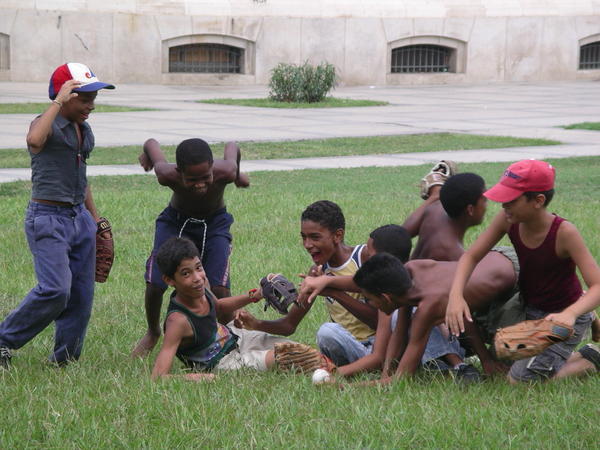 Kids celebrate a brilliant baseball catch in the park