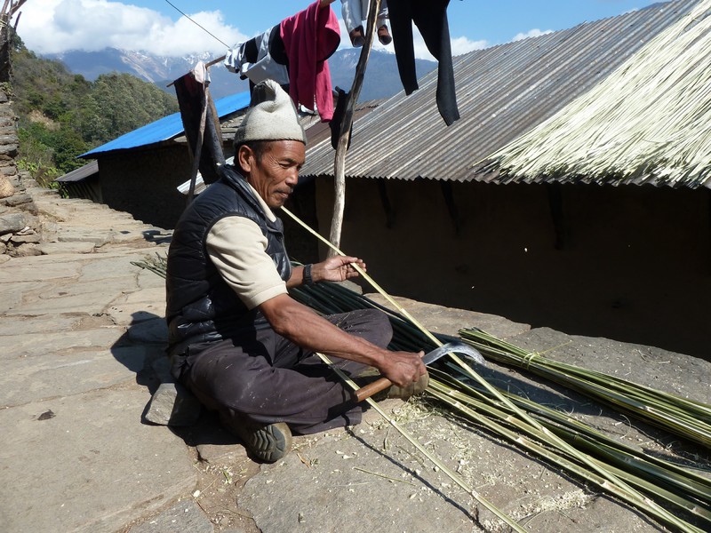 Mansiri's Uncle splitting bamboo with a traditional knife