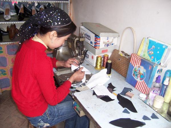 Xiao Mei making shoes