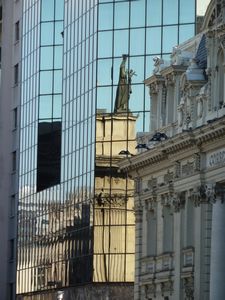 reflection of statue on top of cathedral that was gifted by Peru