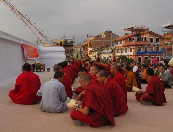 Monks praying by the stupa