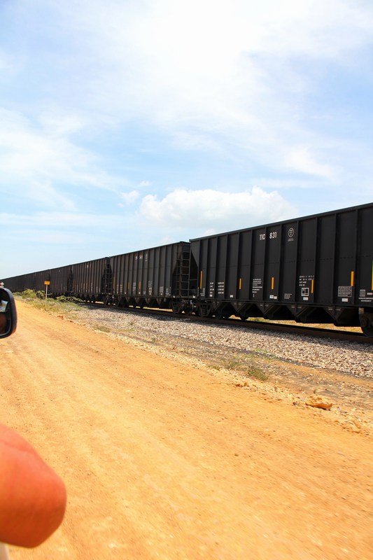 Dust track along the train track bringing coal to the coast