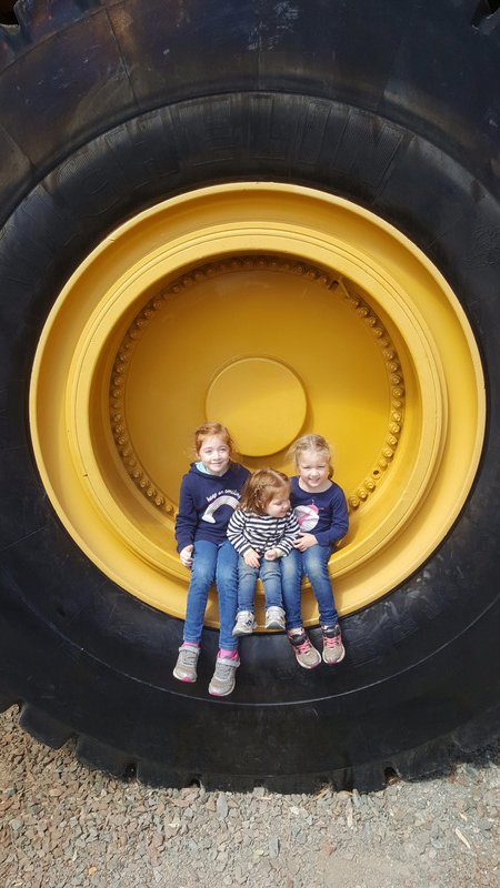 Girls Vs tyre of a Haul Truck