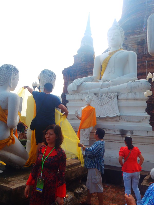 Thai people dressing buddha