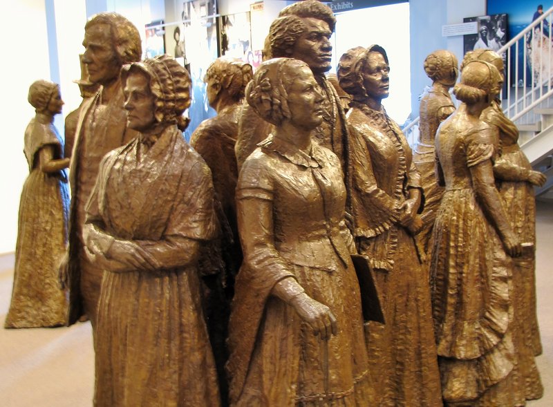 912-106 The Motts on the left, Elizabeth Cady Stanton in middle, and Frederick Douglas behind her
