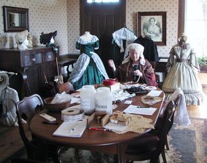 912-208 The Barton House dining room with fashions display