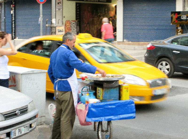 1305-426 Blurry street vendor selling grilled meats