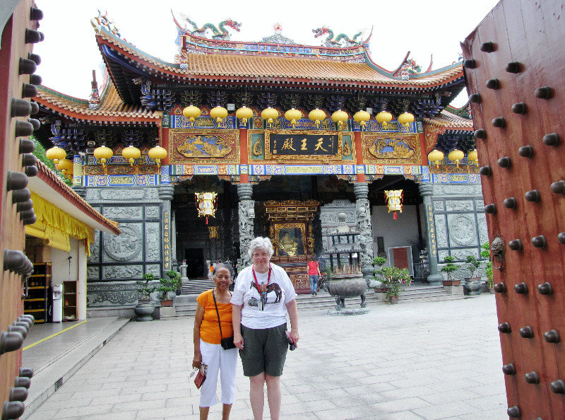 Summary 1304-058 Malaysia--Wanda and Sharon posing in the Temple gate