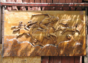 1312-138 Carved wooden panel depicting horsemen protecting herds from predator