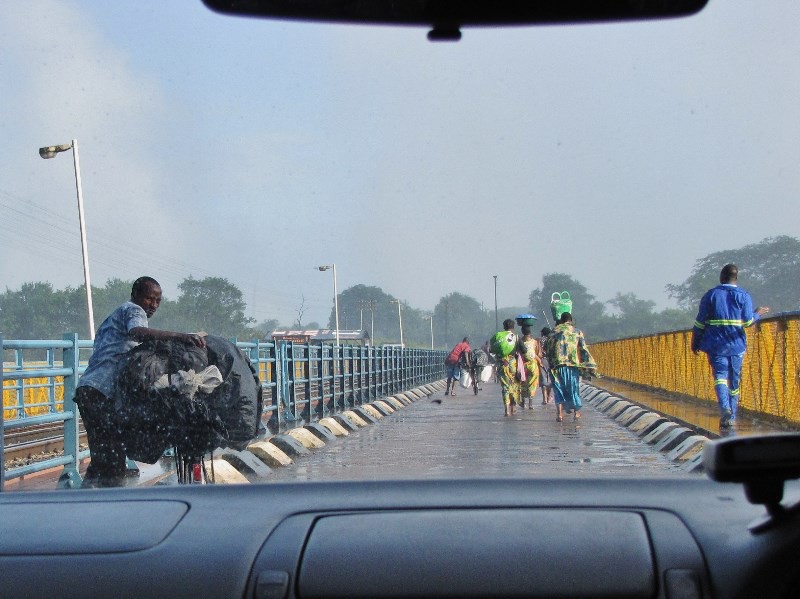 2104-04 People crossing the bridge to Zimbabwe through windshield of our taxi