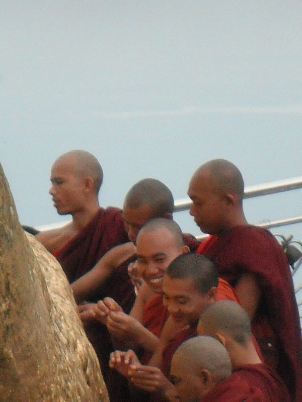 Monks attaching gold leaves