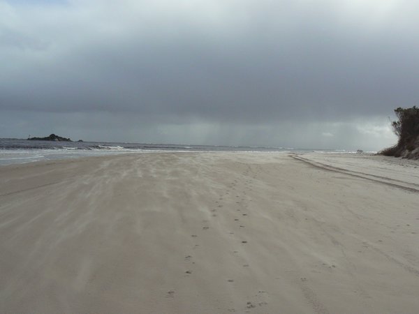 Wind blowing the sand along the beach at Macquarie Heads