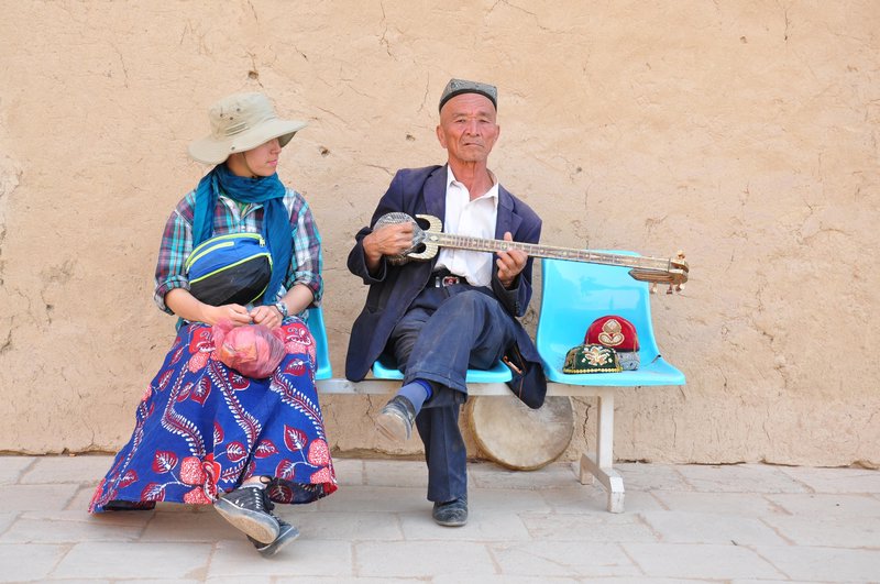 A Uyghur man playing a song