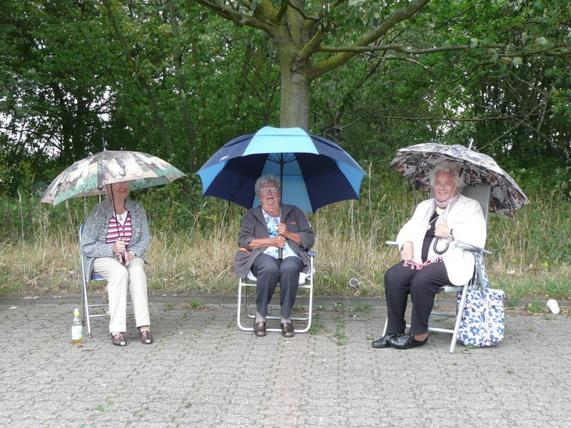three unknown ladies in the rain