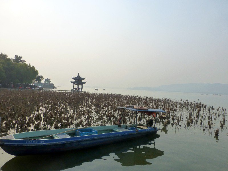 tranquil, hazy West Lake with pavilion