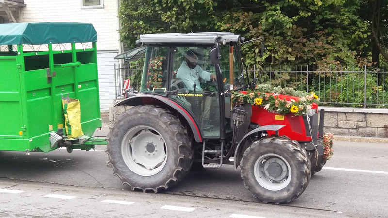 A garlanded tractor at the rear of the Alpabzug