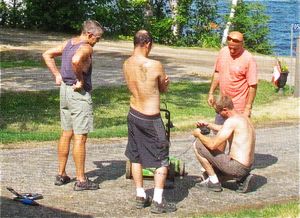 How many dudes does it take to fix a lawnmower?