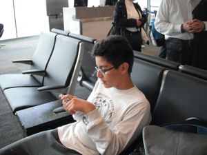 at the airport, having spent all his allowance on electronics 001