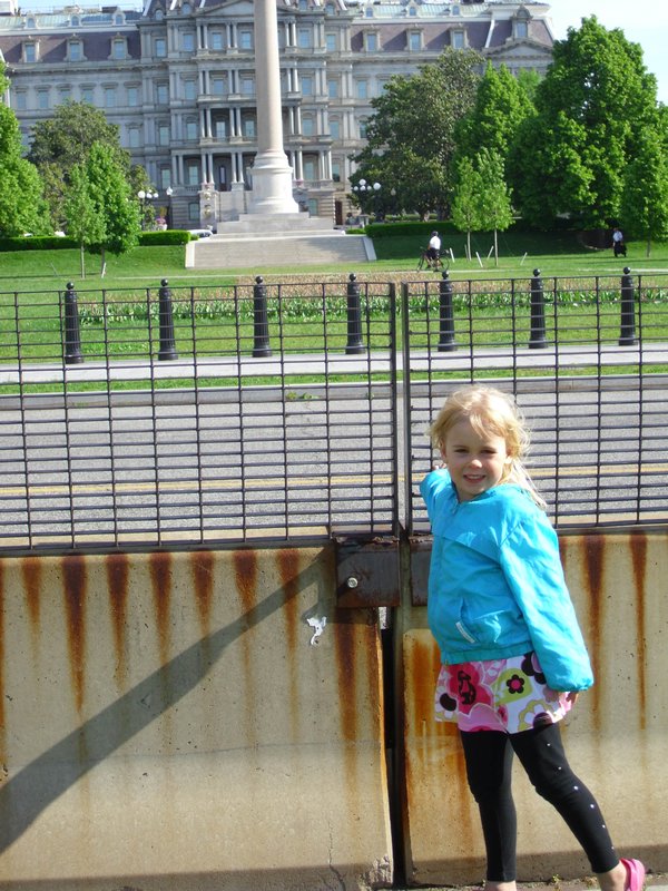 Grace posing in front of White House security fence