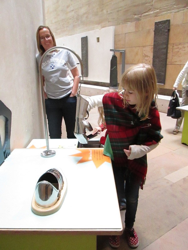 Trying on armor at the National Museum of Scotland