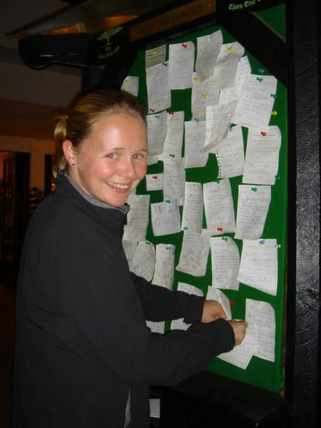 Gemma pinning up our message to our fellow overlanding travelers at the Thorn Tree cafe
