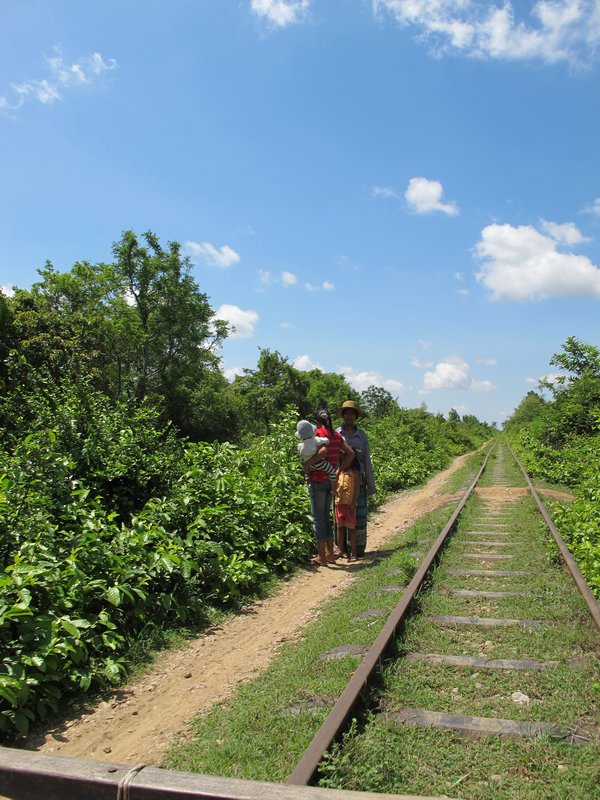People walking along the railway