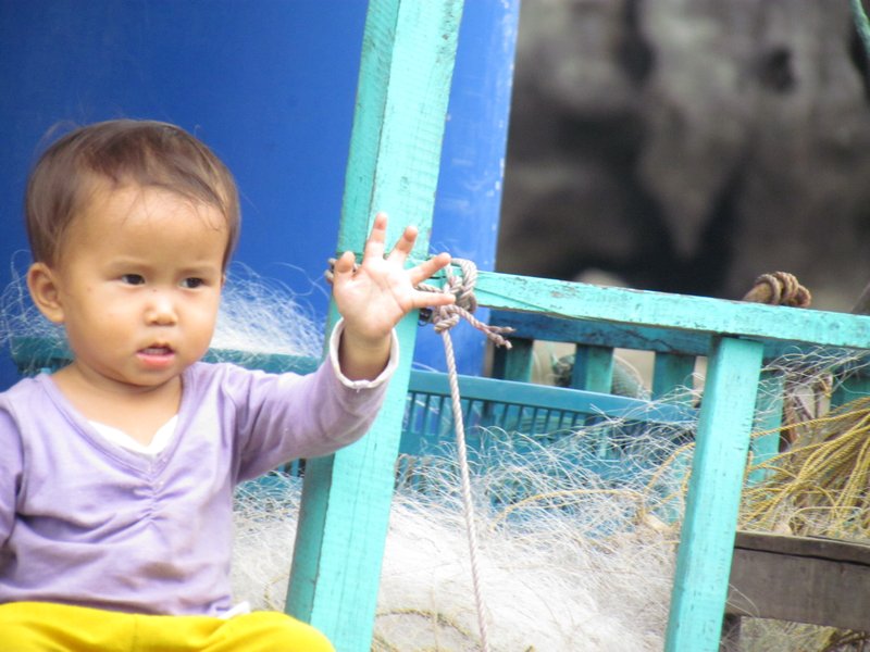 A little girl at the floating fishing village....so cute!