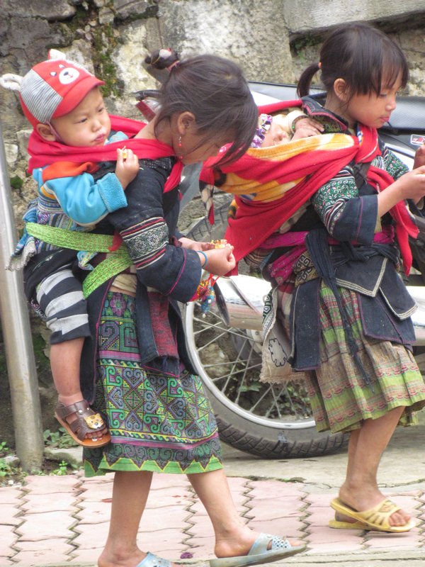 Children carrying their baby brothers and sisters