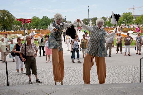 period costumed stilt walkers at flower show