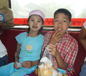 Snacks at the back of the bus - note the sunscreen-makeup on the little girl
