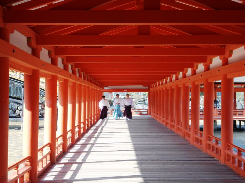 Crossing the bridge at Itsukushima-Jinja Temple