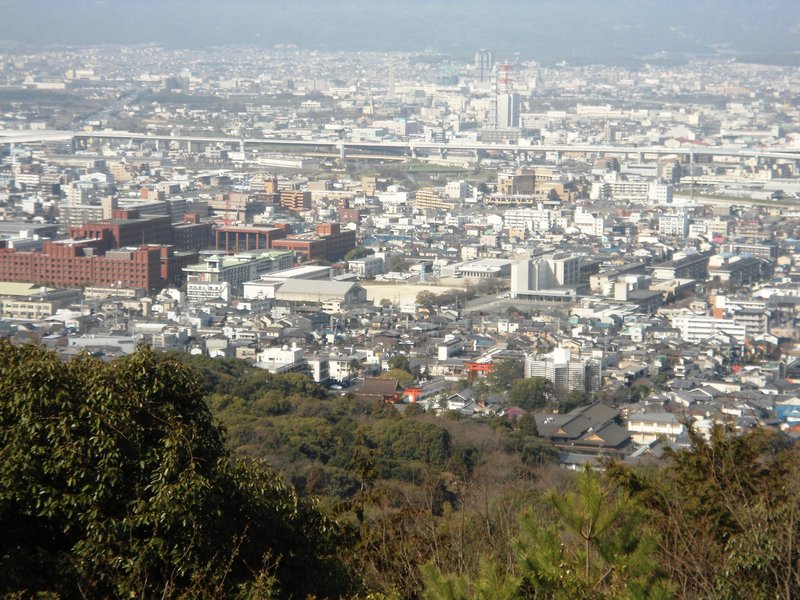 Kyoto in the background with the stasrt of the gates barly visible at the bottom of the hill
