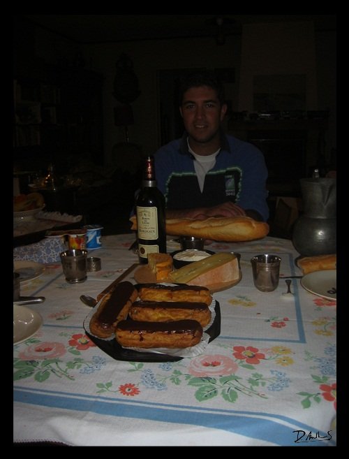 Dinner with cheese, bordeaux, baguette and eclaires
