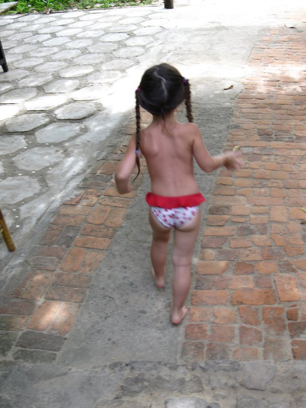 3 year old French girl running to the beach