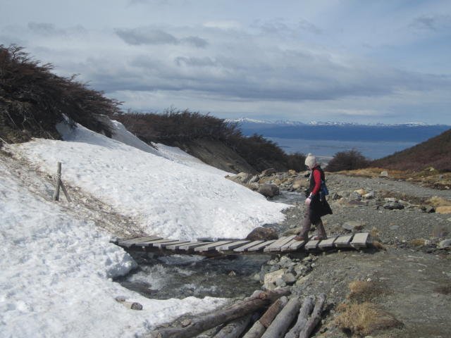 Shelley crossing a bridge on the way to the Martial Glacier