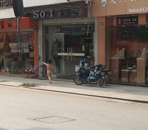 Naked & barefoot child on the streets