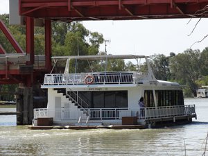 House Boat heads under bridge