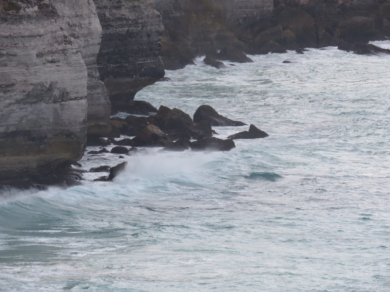 Surf breaking on Bunda Cliffs