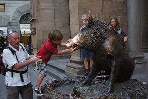 Rubbing the boar's nose for luck