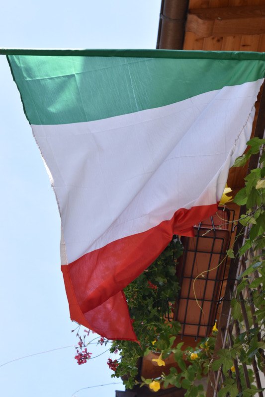 Italian flags hanging off balconies in Donnas