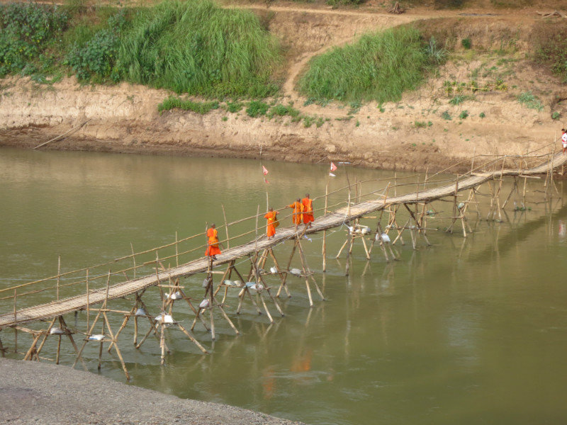 monks on a bridge