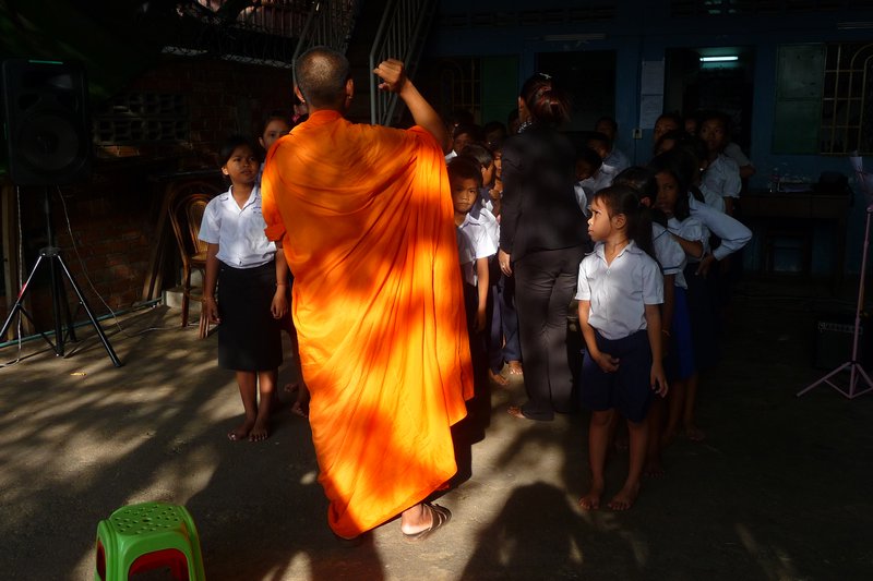 Monk addressing the students