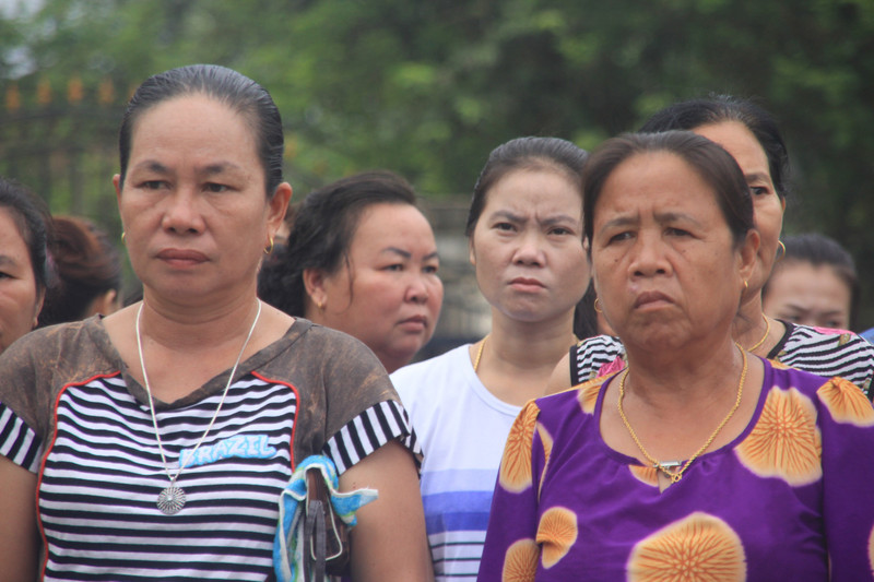 Villagers listening at mobilization event