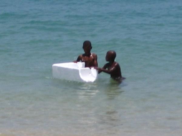 Local boys enjoying a piece of polystyrene packing crate