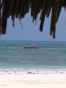Under the shade of our african thatched beach umbrella