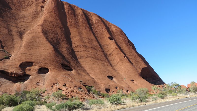 Close up view of Ayers Rock while traveling around the base