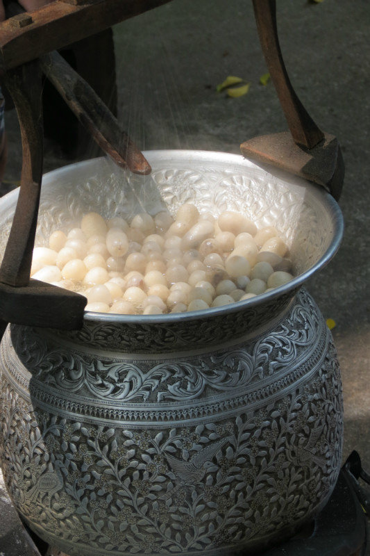 Silk worms being steams before the silk threads are pulled.