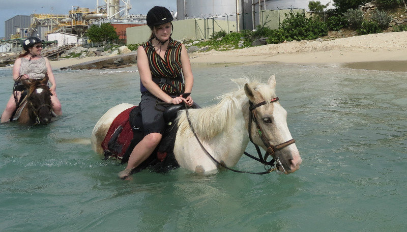 Jennifer and her horse walking in the ocean - St. Maarten