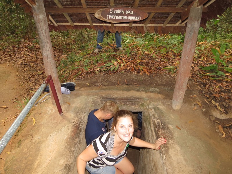 Jenny entering one of the Củ Chi tunnels